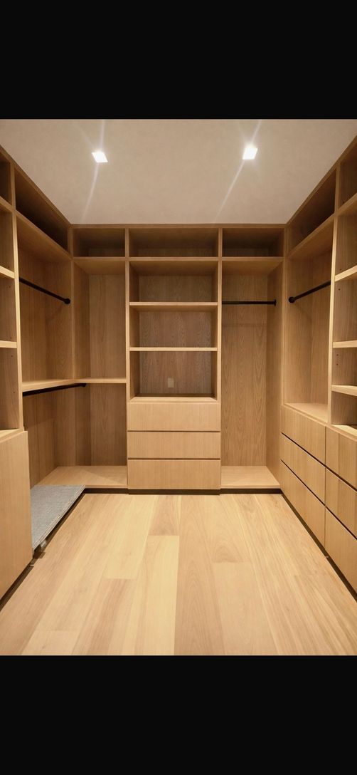  1 of 2 custom oak closet in the 2nd floor primary hallway leading to the bathroom 