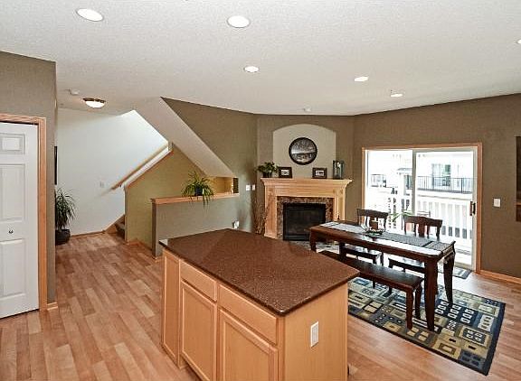 Dining area shows off a beautiful fireplace and patio door to deck.