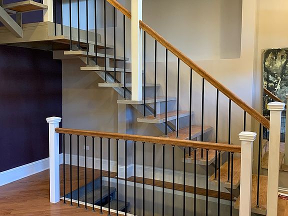 Floating stairs to Master Suite and open stairs to basement.
