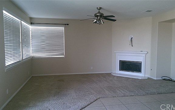 Family room has fireplace and ceiling fans.
