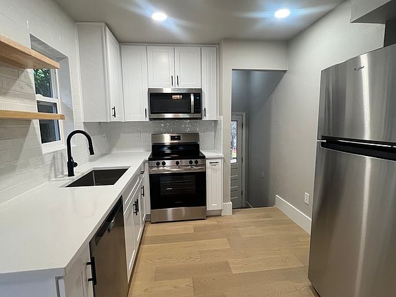 New kitchen with quartz counters, new cabinets, sink, hardware, flooring and appliances.