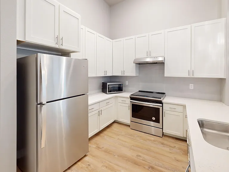 The Bellview's kitchen comes equipped with stainless steel appliances, including a refrigerator, microwave, glass-top stove, and dishwasher. The Bellview's kitchen comes equipped with stainless steel appliances, including a refrigerator, microwave, glass-