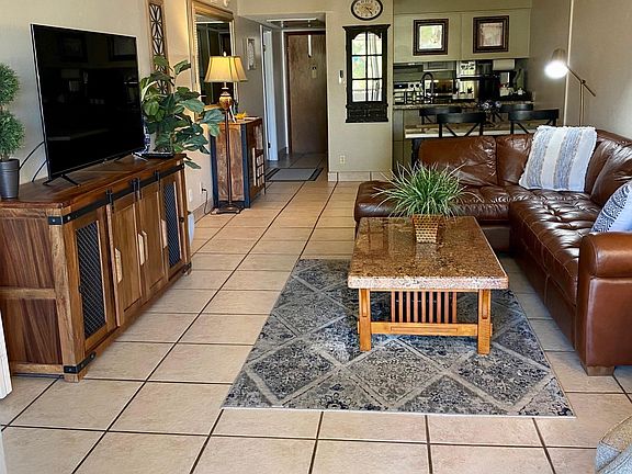 Front entry, galley kitchen, dining, and living area. Open the drapes to let fill the room with light.