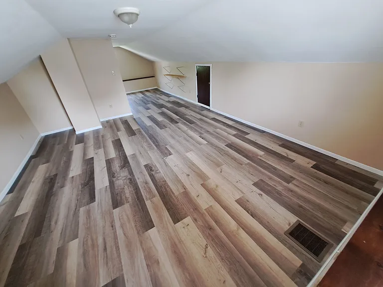 Upstairs bedroom in finished attic. Usually hot in the summer. You may add a window AC unit.
