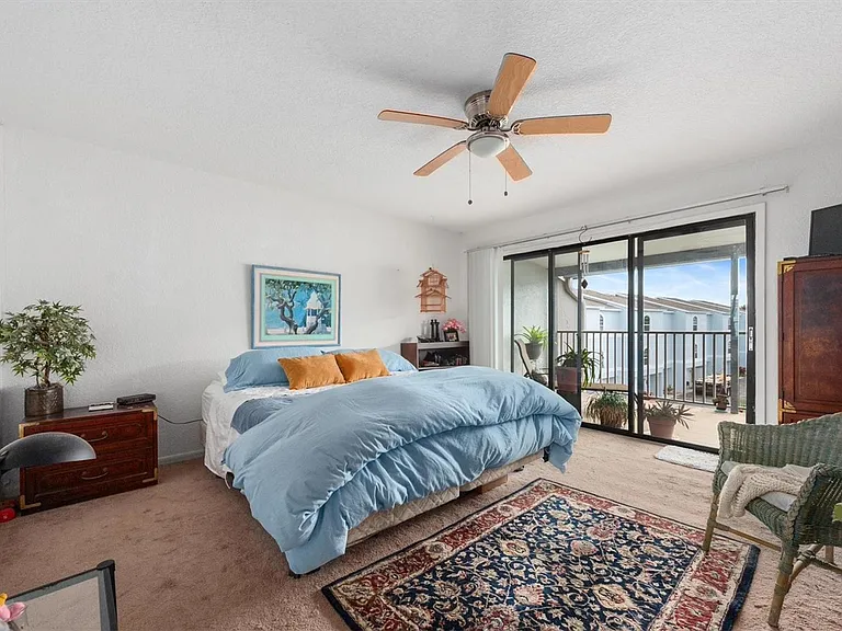 Master bedroom with picture of balcony.