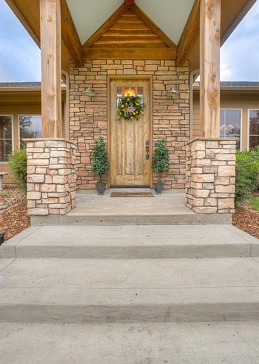 The elegant entry to this beautiful home. The home features custom cedar siding with stone accents.