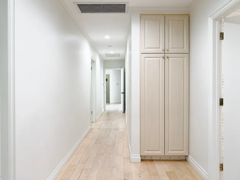 Long hallway with a floor-to-ceiling storage cabinet showcases smart design in this Beverly Hills luxury rental home at 1094 Garden Lane, a 90210 lease opportunity.
