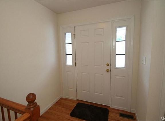 Wood foyer and open stairwell.