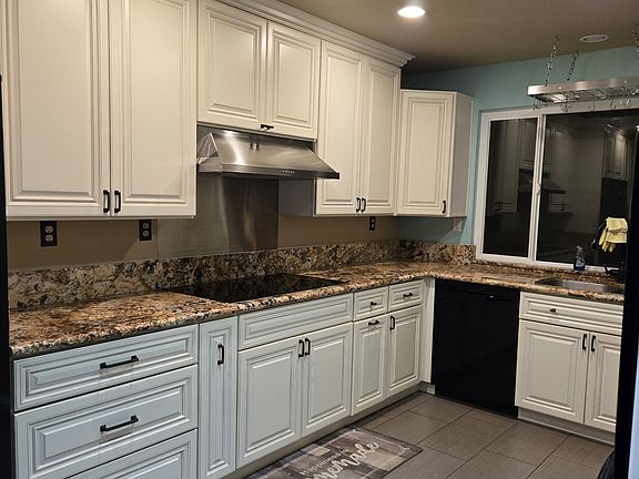 View of kitchen cooktop and sink areas