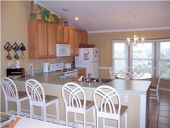 Kitchen area, dining table and bar stools for additional seating