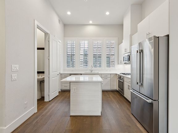 Kitchen with White Quartz and Stainless Steel Appliances