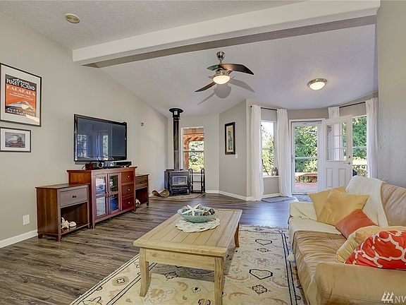Enjoy a large cozy family room. Plenty of space for your entertainment center, with vaulted ceilings and wood burning fireplace, this is just the right spot to relax. 