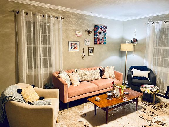 Here's a shot of the living room furnished by our previous tenant. You can see the single window on the left and part of the double windows on the right. This would be the view from the hallway.