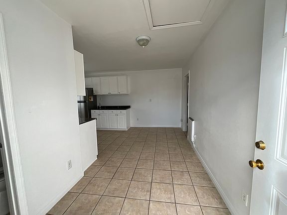 You enter into the living room with tile flooring