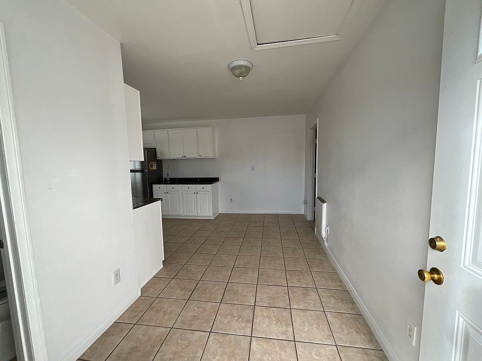 You enter into the living room with tile flooring