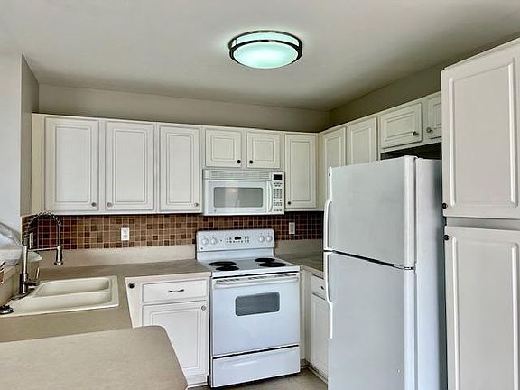 kitchen area features all appliances