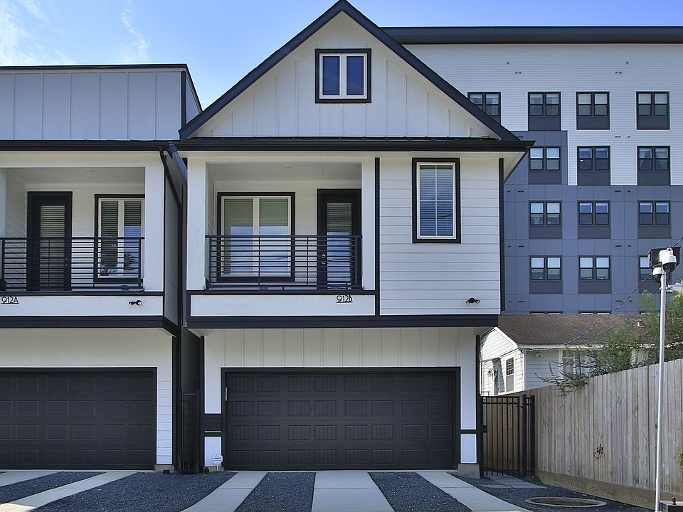 Sleek detached townhome facade with dual garages and modern design in Shady Acres, Houston.