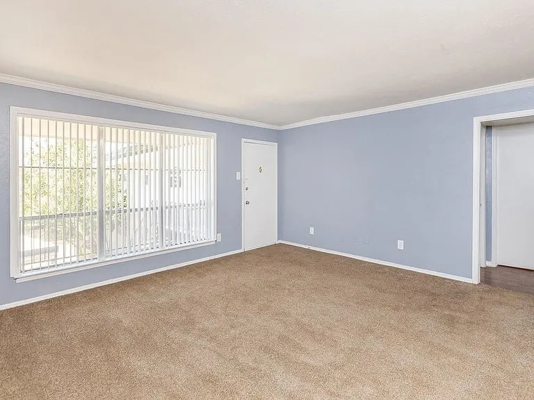 Comfortable bedroom with neutral tones, large closet space, and ceiling fan for year-round comfort.