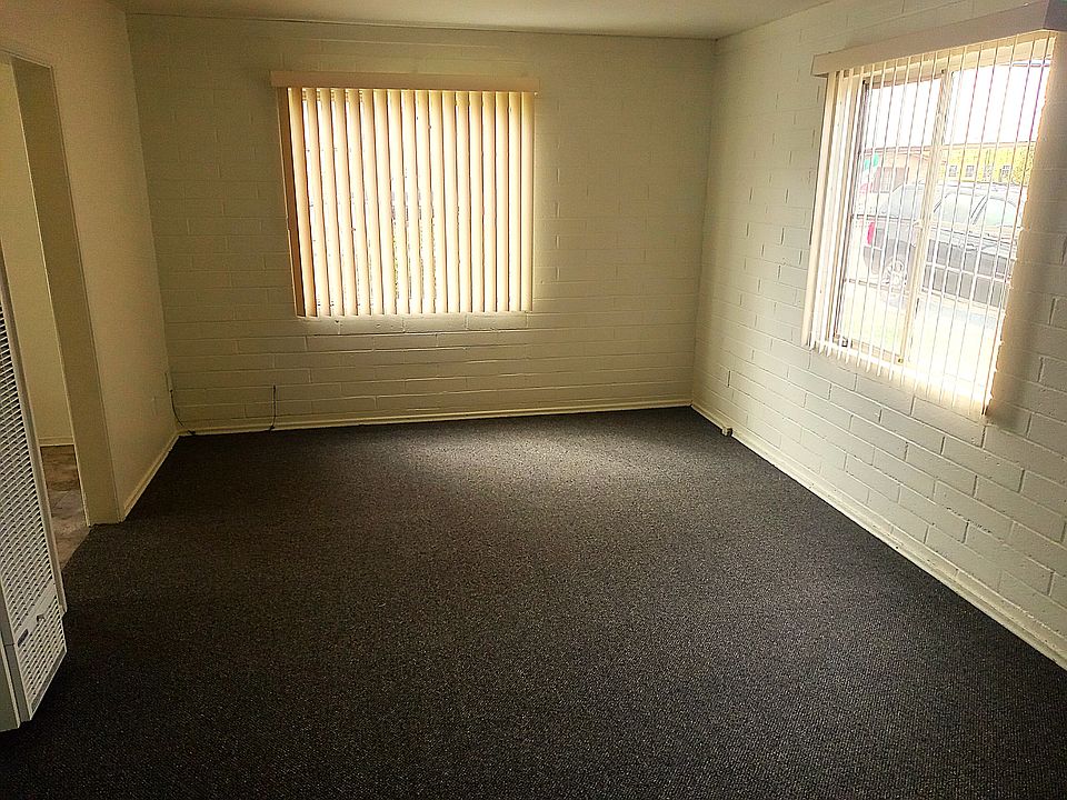 Living room. Kitchen entrance depicted on far left. New carpet, paint, and blinds.
