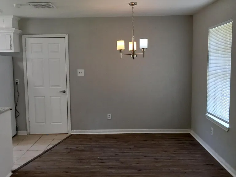 Bright dining space with kitchen access to garage and laundry space