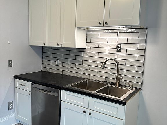 Designer faucet features multiple settings and tall cabinets for extra storage.