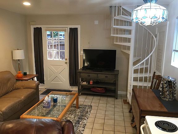 Spiral staircase connecting living room, kitchen and bathroom to upstairs large bedroom.