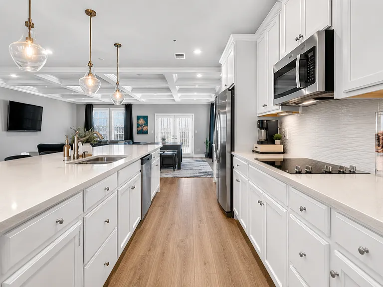 Kitchen on main level with long island (photo is virtually staged)
