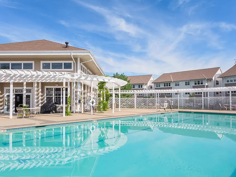 Resort-Style Pool and Pergola and Chaise Lounge Chairs