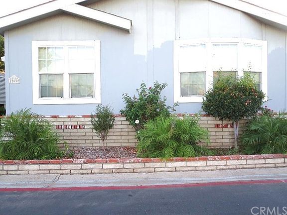 Closer view of the custom brick planters with drought tolerant plants.