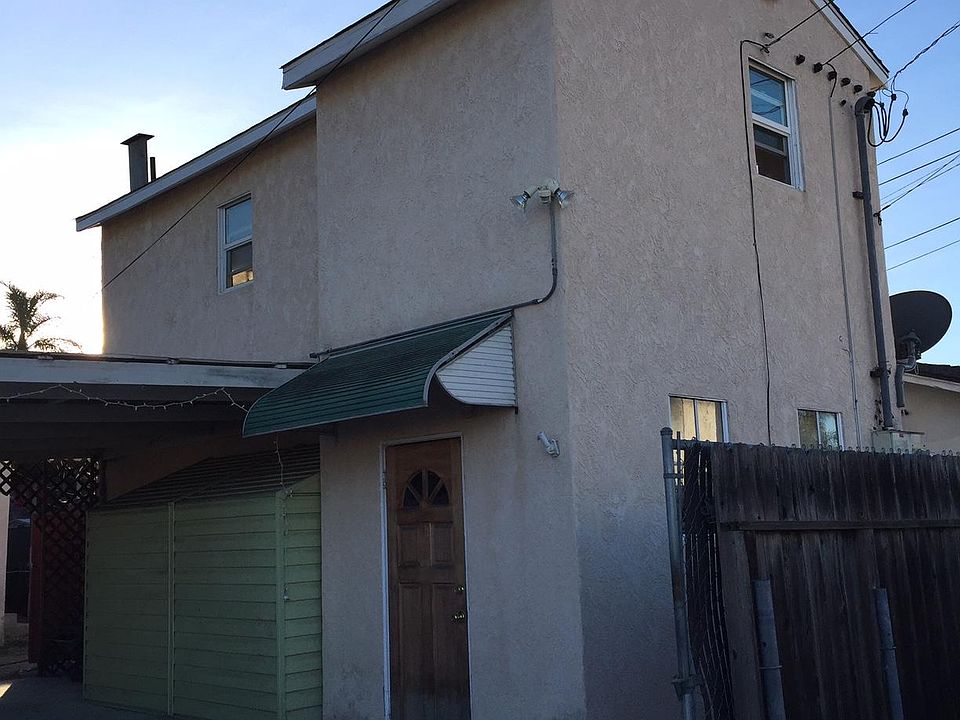 Exterior of Apartment, the alley is on the other side of the fence.