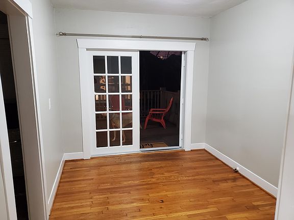 French doors at back entrance leads to to a private balcony. Inside are perfect for a dining room table.