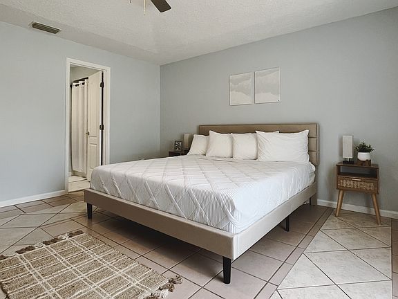 Master bedroom with walk-in closet and smart TV