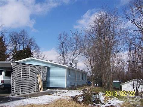 Carport at side of house, slab parking and sidewalk to door
