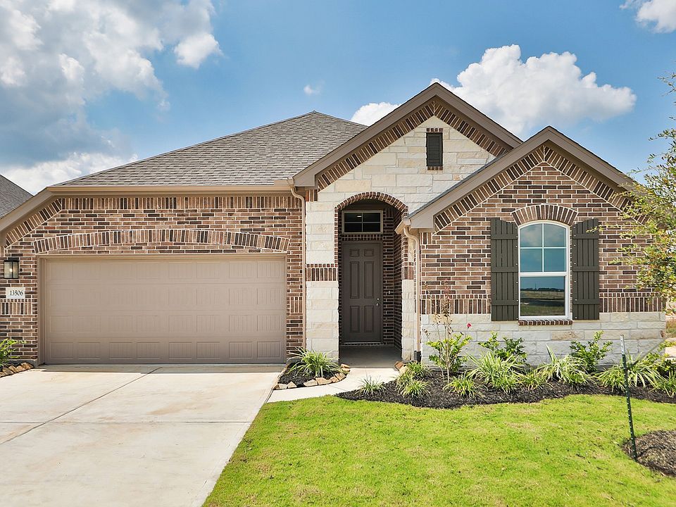 Elegant arched brick entrance and custom wood shutters enhance Creekhaven s charm.