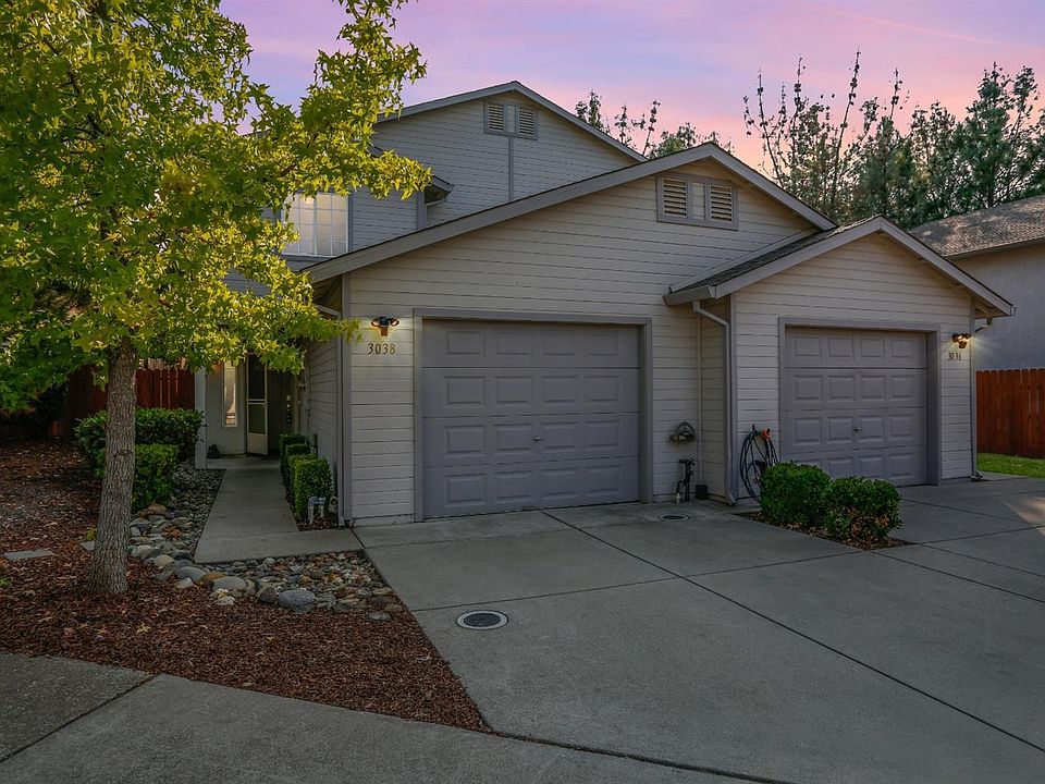A view of the front of the home & driveway near sunset.