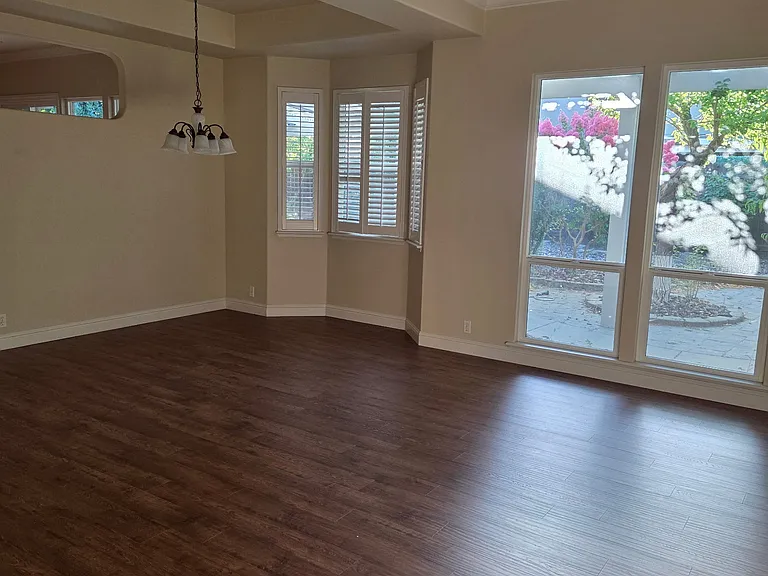 Living room, formal dining room with plantation blinds