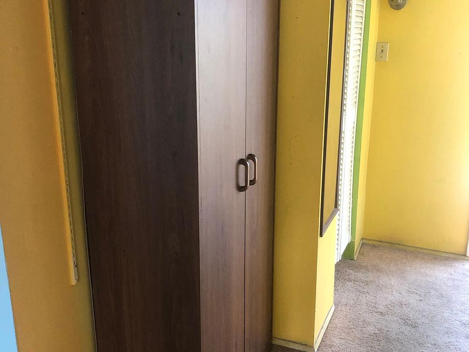 Clothes closet next to another clothes closet.