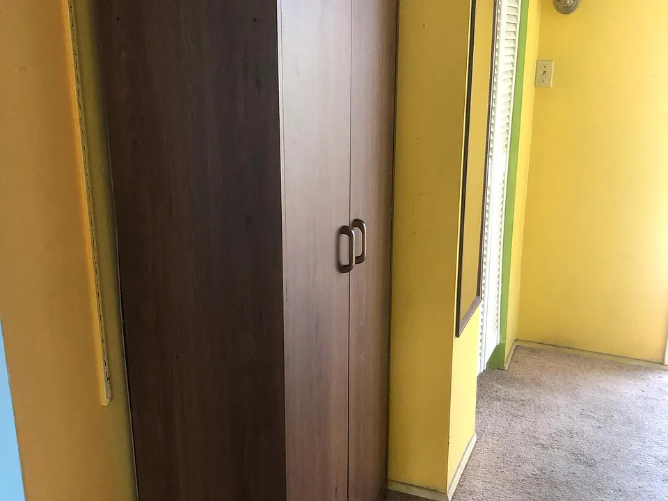 Clothes closet next to another clothes closet.
