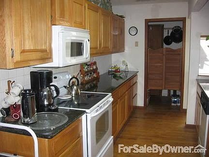 Stairs to loft and upstairs rooms
						:
						Main House, looking towards dining area and windows to porch and lake