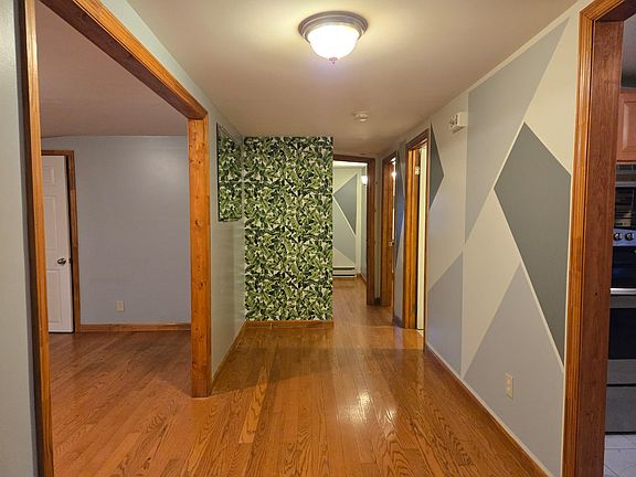 From front door looking at the hallway to the 2 bedrooms. Living room on the left and kitchen on the right.
