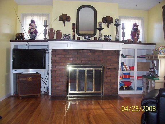 Living room with fireplace, large mantle and built-ins