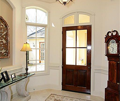 Beautiful foyer with double crown moulding and tile floor.
