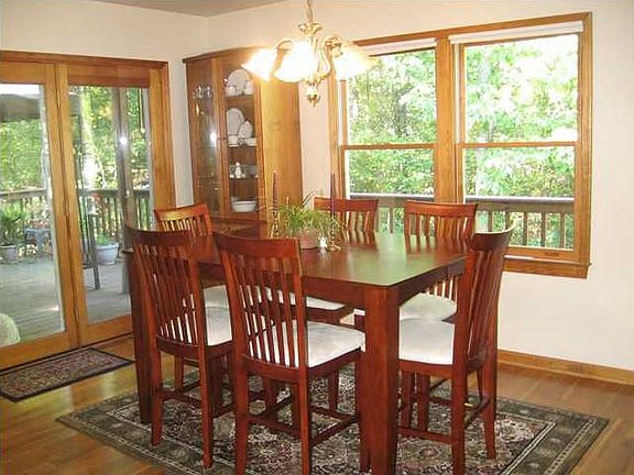 Elegant dining room with french doors leading to deck.