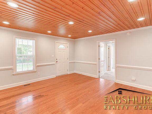 Living room with custom tongue and groove ceiling, chair rail and LED recessed lighting