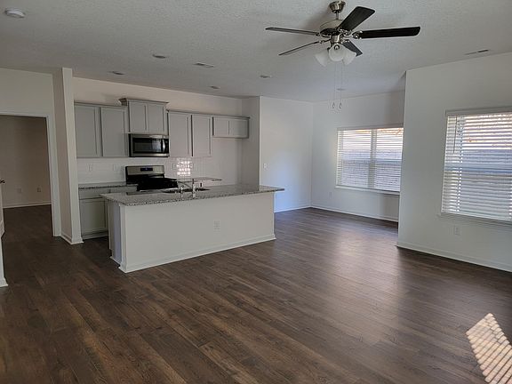 Open Kitchen, Dining, and Living Space. Patio door off of dining area.