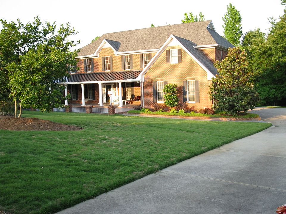 Front of house faces west; side-load garage. 1 acre of Zoysia grass
