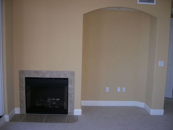 Fireplace and entertainment nook in Family Room, next to balcony sliding doors