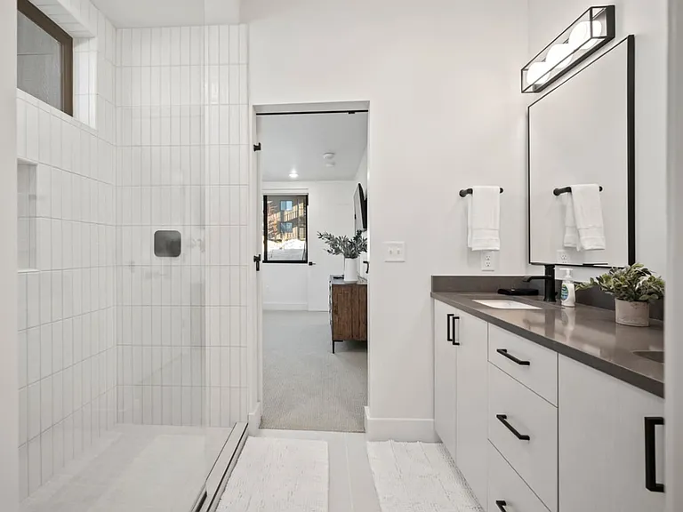Master Bath with his and hers sinks, walk in shower, and separate toilet room