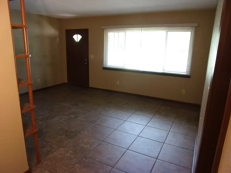 LIVING ROOM OVERLOOKING FRONT DOOR - NEW WOOD-LIKE BLINDS