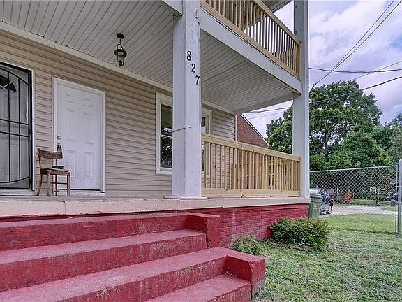 The downstairs unit boasts a large front porch and the upstairs unit offers a balcony.
